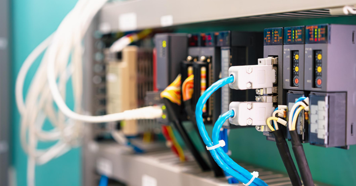 Industrial automation control panel containing PLC modules and networking equipment.